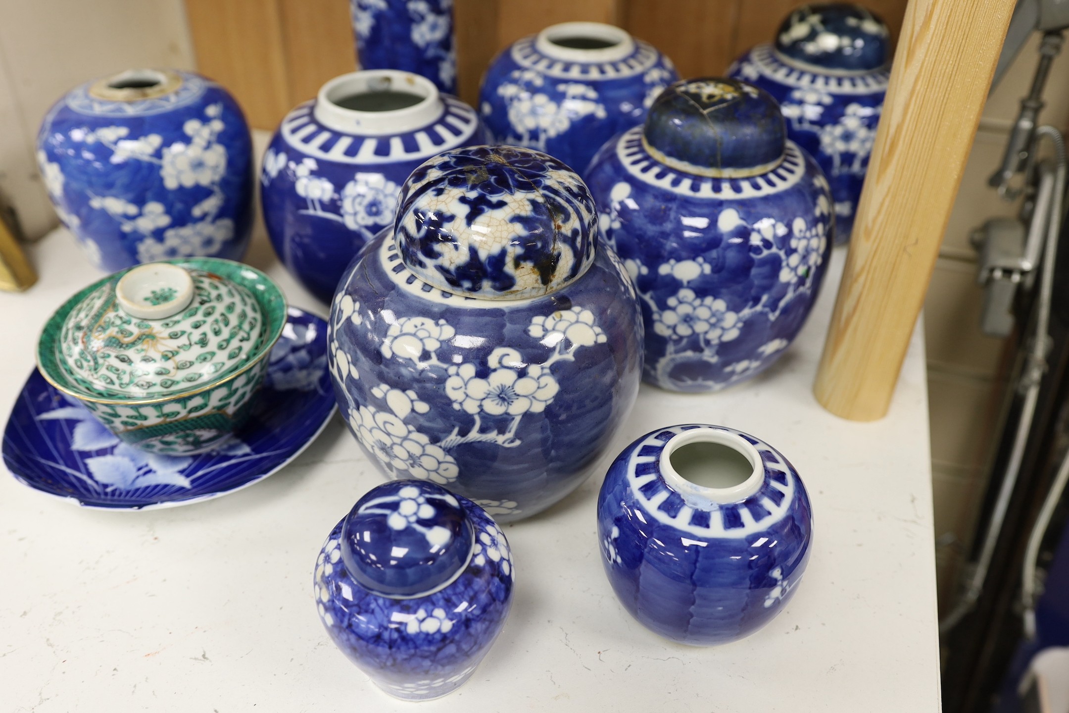 Eight Chinese blue and white ginger jars, one prunus vase and two others, the vase 25 cm high